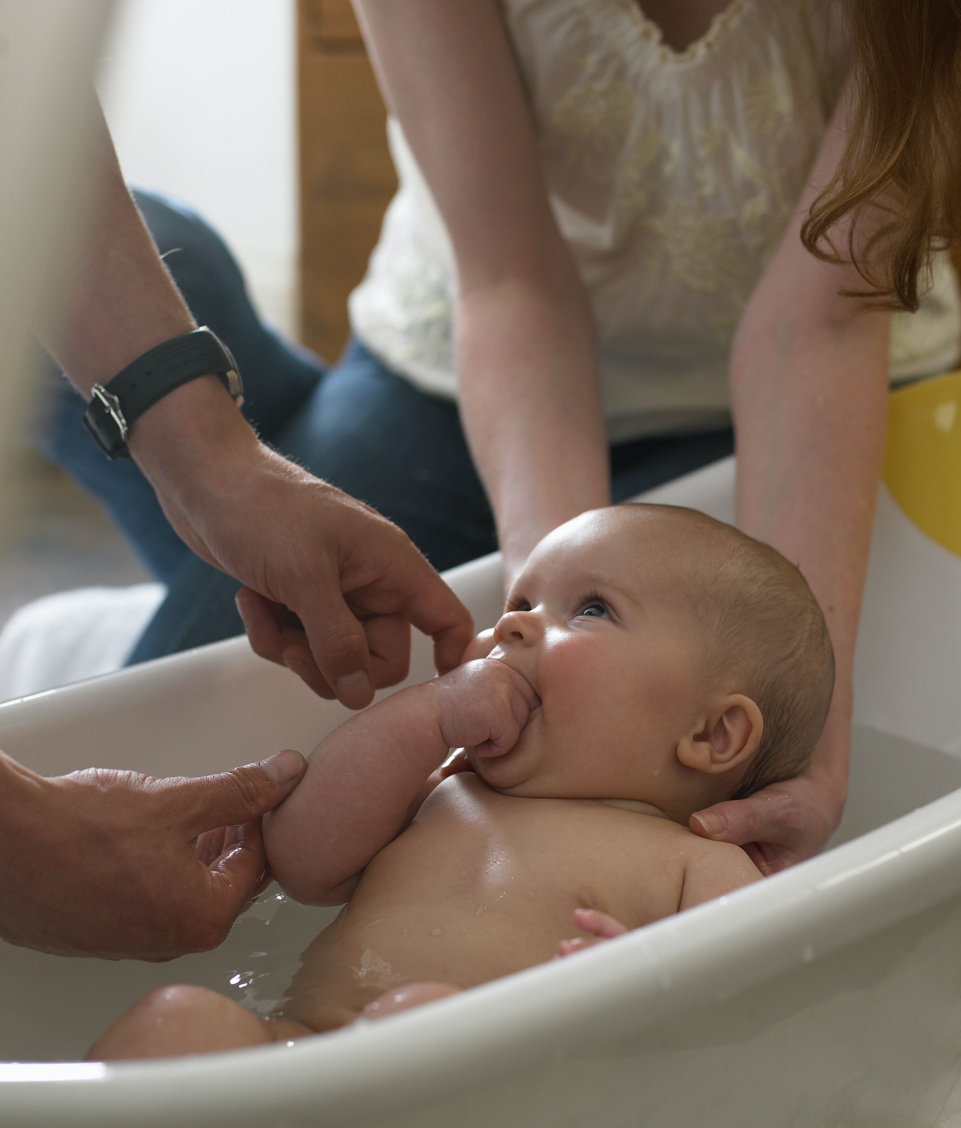 Happy baby being bathed.